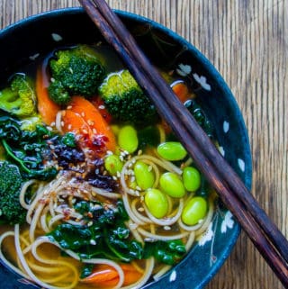 Japanese Miso Soup with Edamame in Black Bowl with Chopsticks