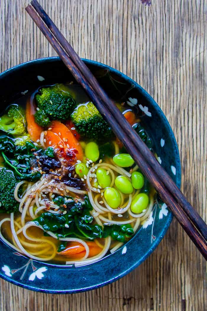 Japanese Miso Soup with Edamame in Black Bowl with Chopsticks