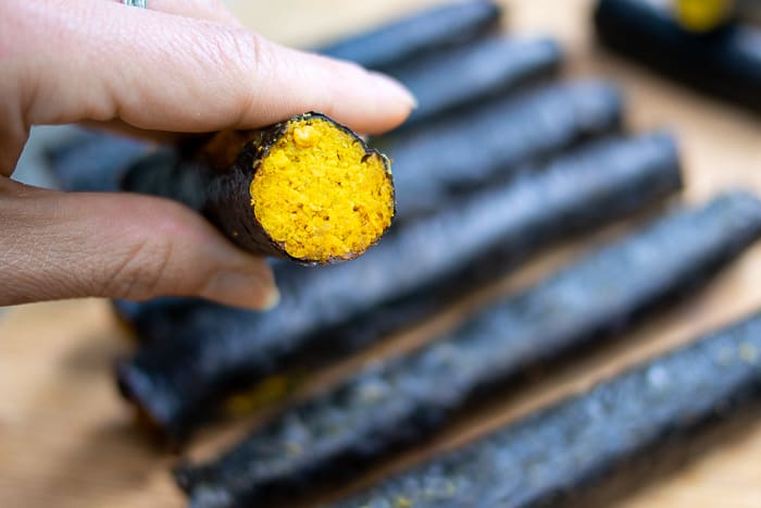 Hand holding Raw Nori Sticks