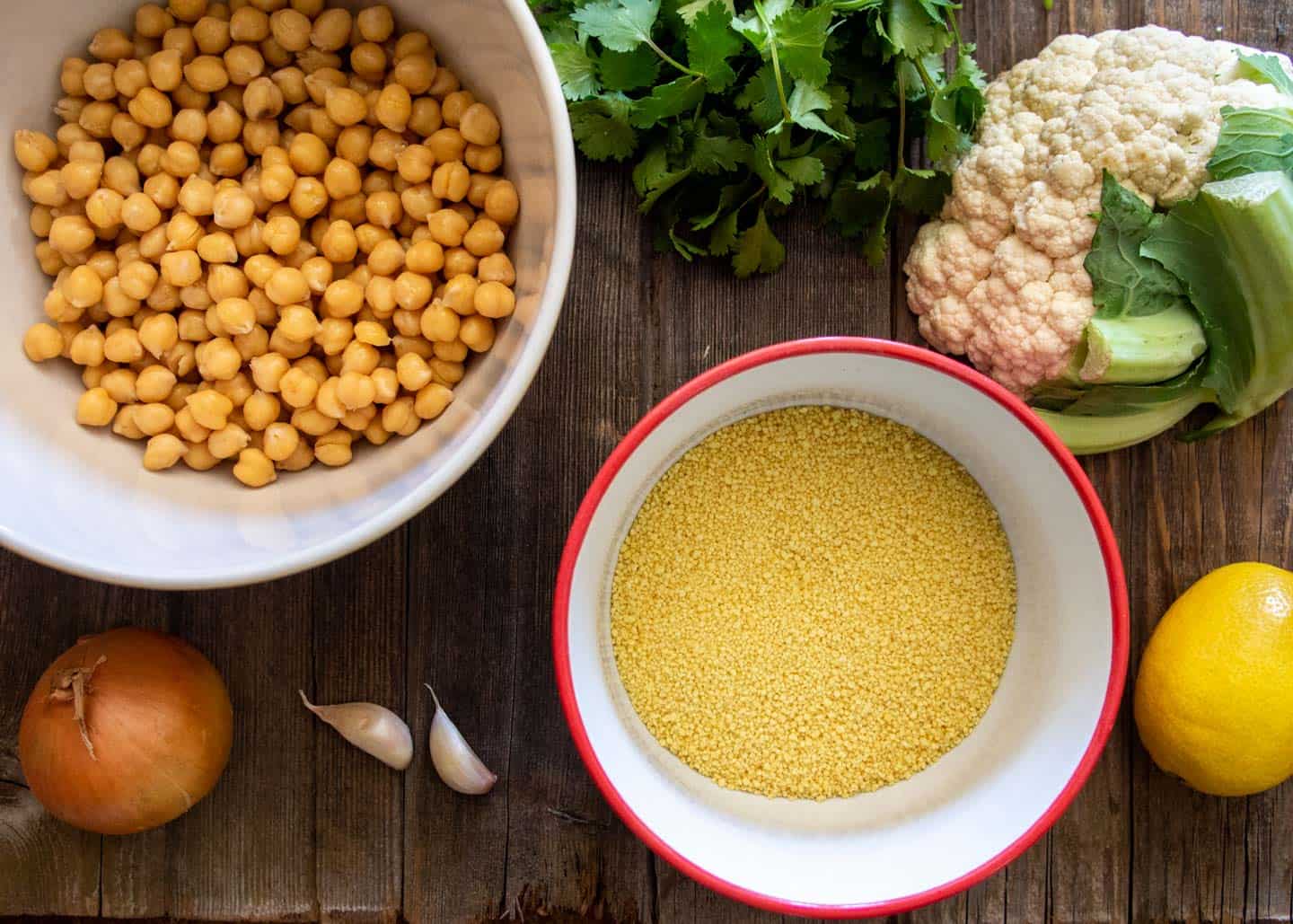 Cooked chickpeas, dried couscous, cauliflower, lemon, onion, garlic and cilantro