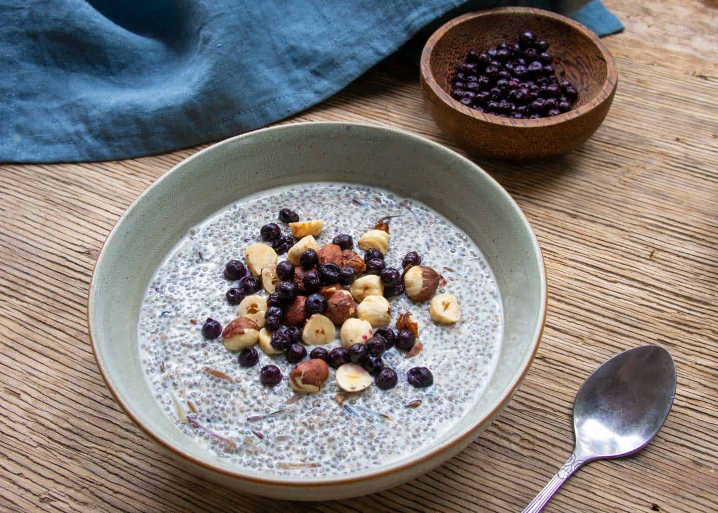 Close Chia Pudding Hazelnuts Berries Blue Linen