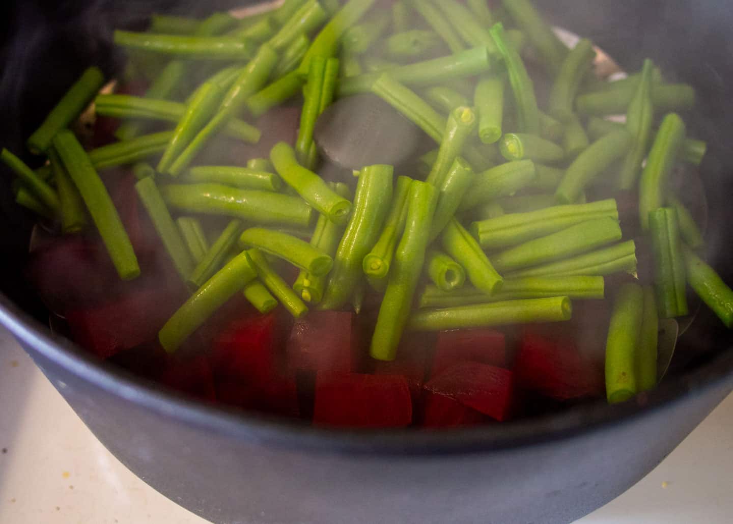 Add beans on top of beets in steamer