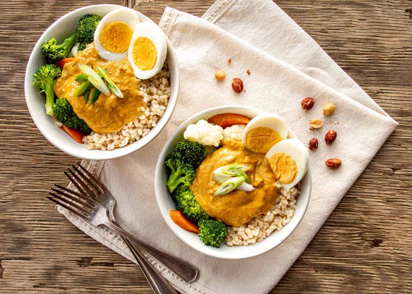 close up of peanut sauce on vegetables with boiled eggs