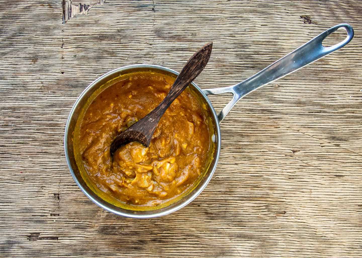 Peanut sauce ingredients mixed in silver saucepan