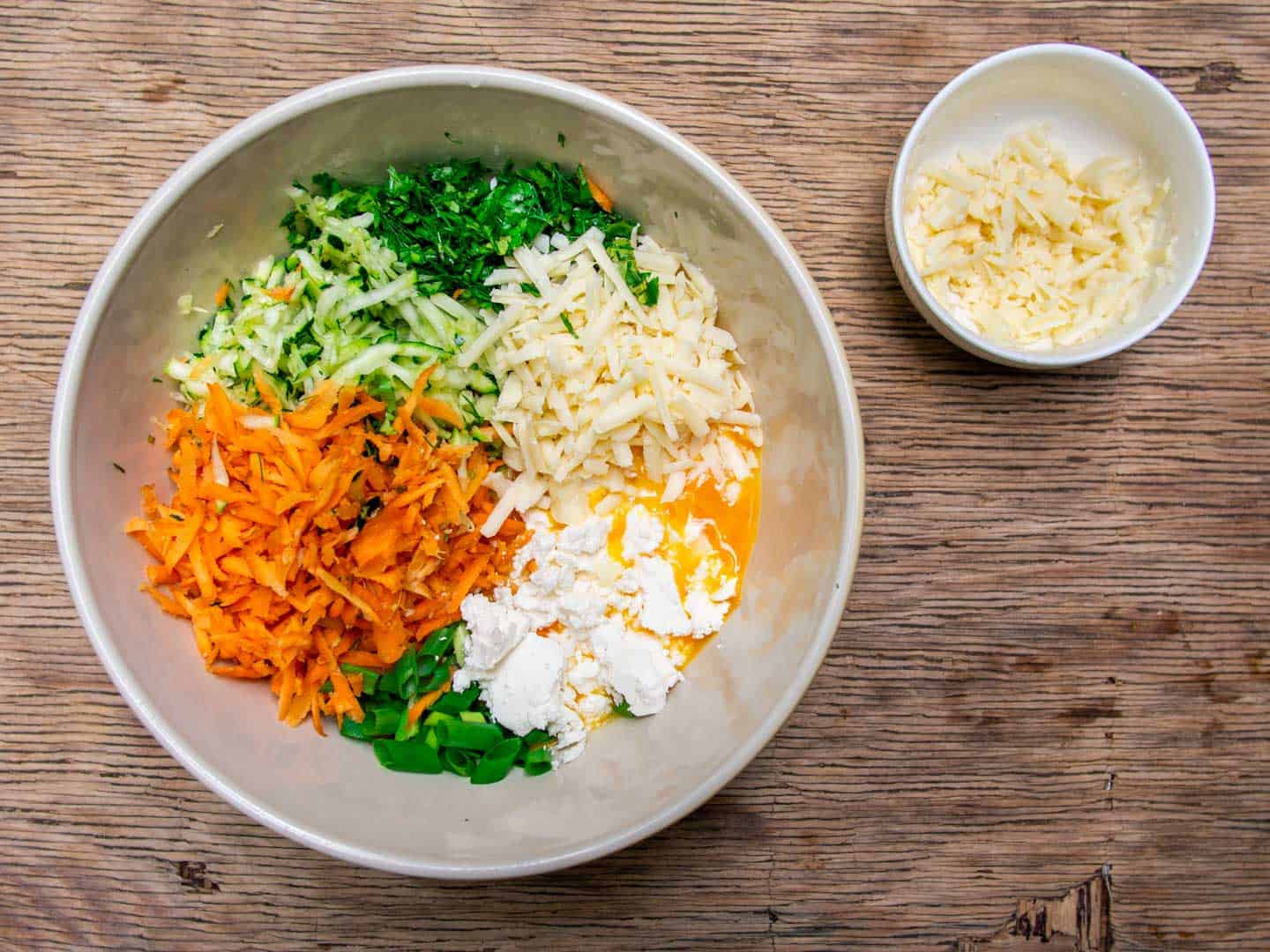 Ingredients for vegetable quiche added to mixing bowl