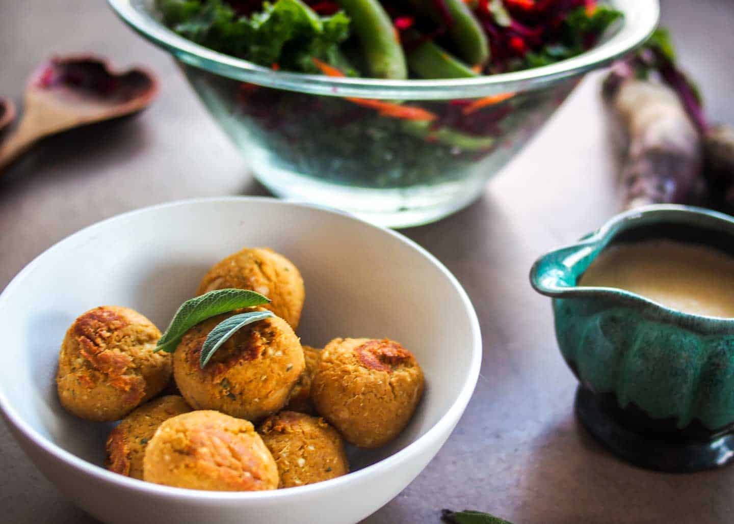 Close up of vegan meatballs with salad in the back