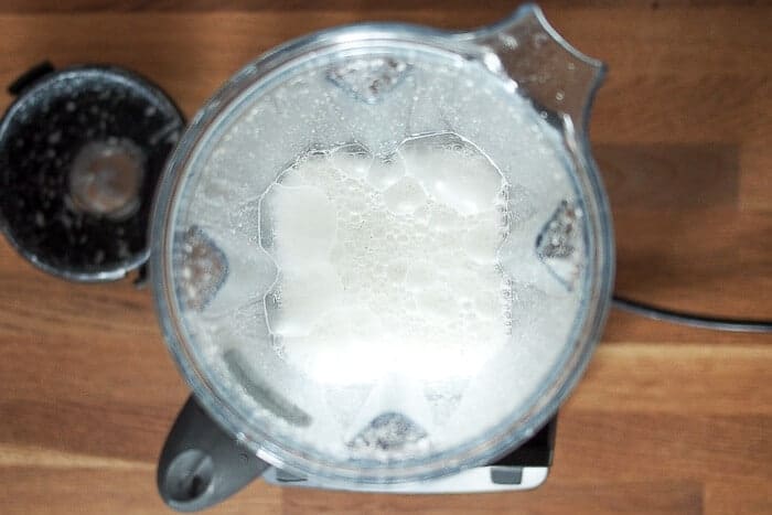 Homemade Hemp Milk On Wooden Counter Blended in Vitamix 