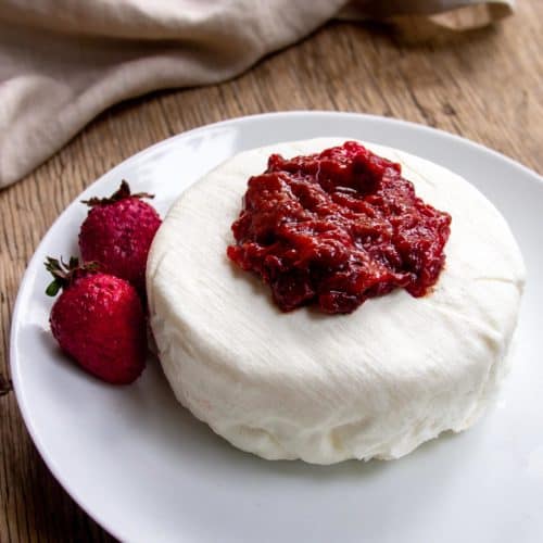 Labneh on white plate topped with berries