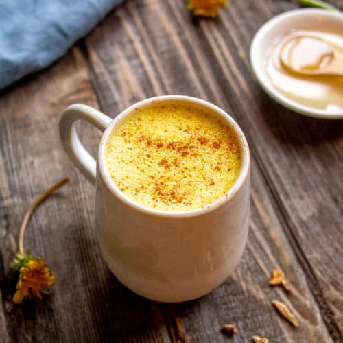 Dandelion Root Latte in White Mug with Dandelion Flowers