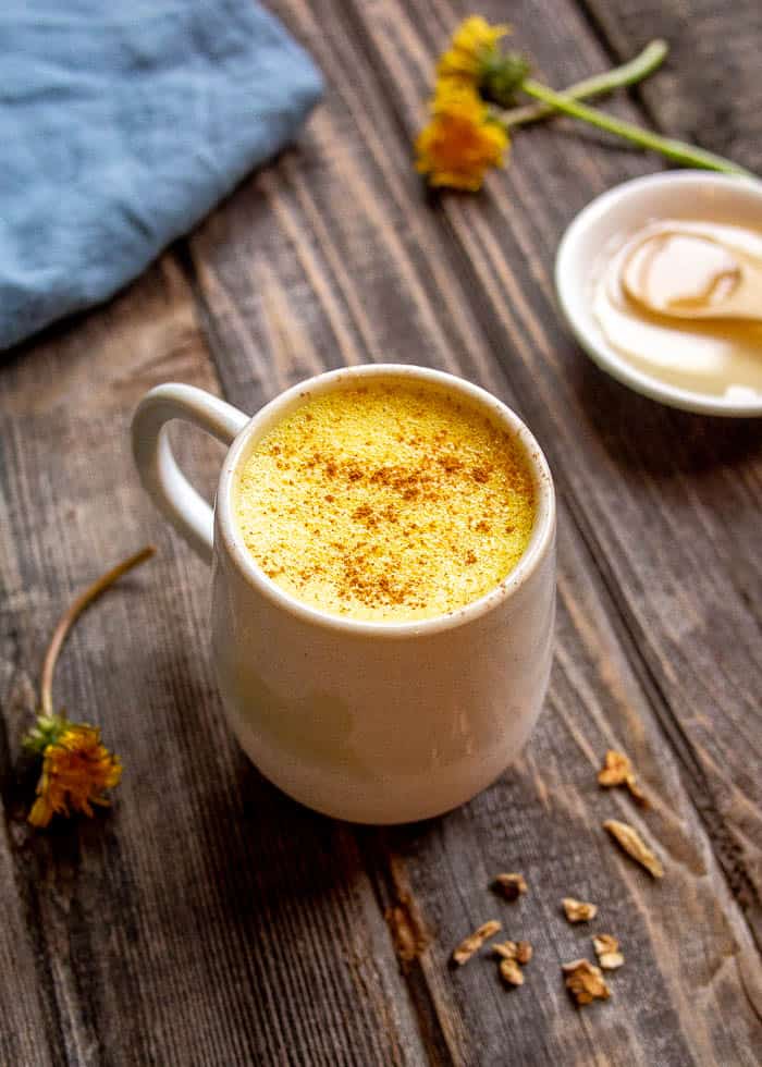 Dandelion Root Latte in White Mug with Dandelion Flowers