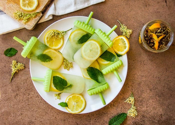 Popsicles made with Elderflower, Lemon and Mint on White Plate