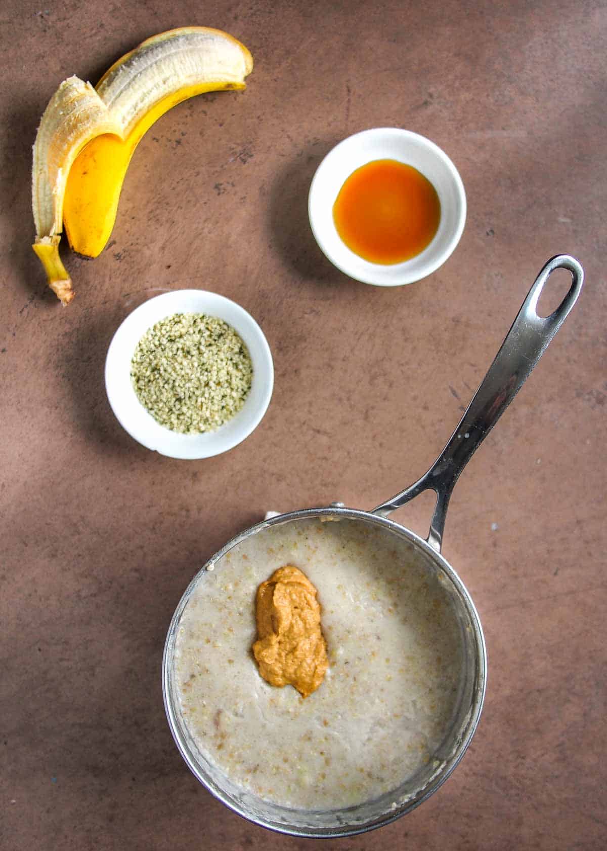 Silver Saucepan With Cooked Oats and Peanut Butter Added