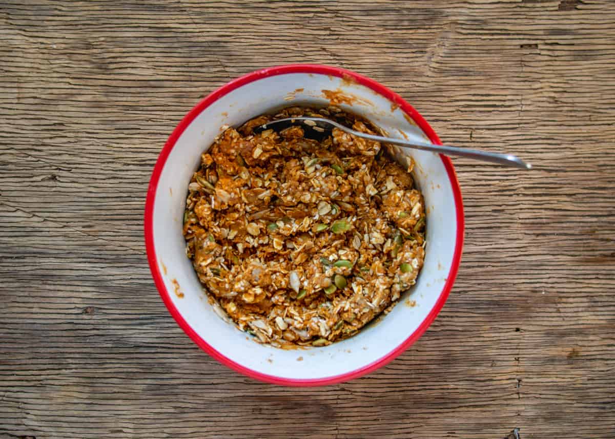 Ingredients for cookies mixed in bowl with a spoon