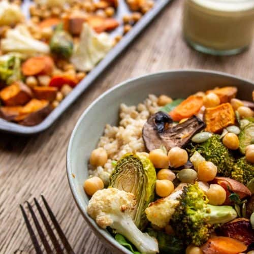 bowl of roasted vegetables with baking tray in back