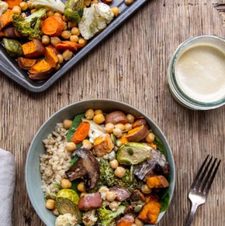 Roasted vegetables in blue bowl with baking tray on side