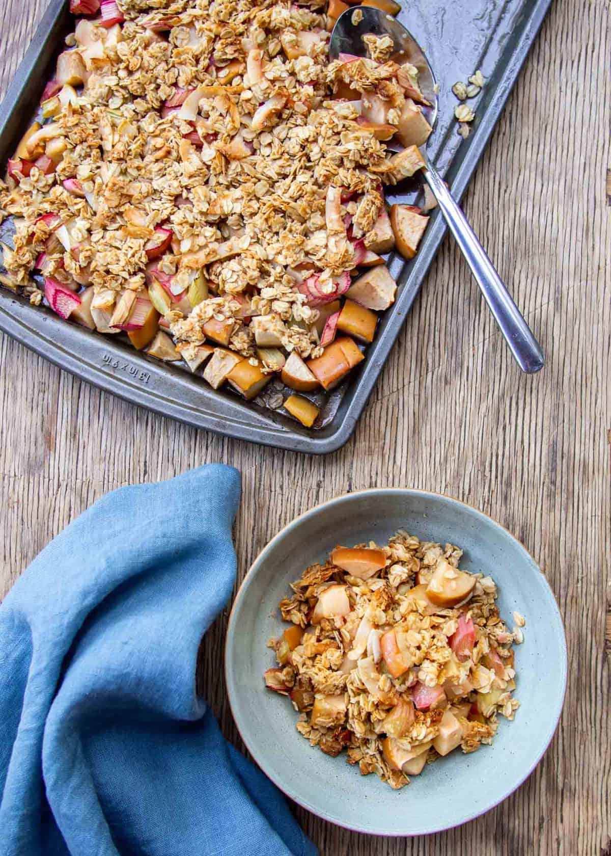 Roasted Rhubarb Apple Crisp in Blue Bowl with Baking Tray